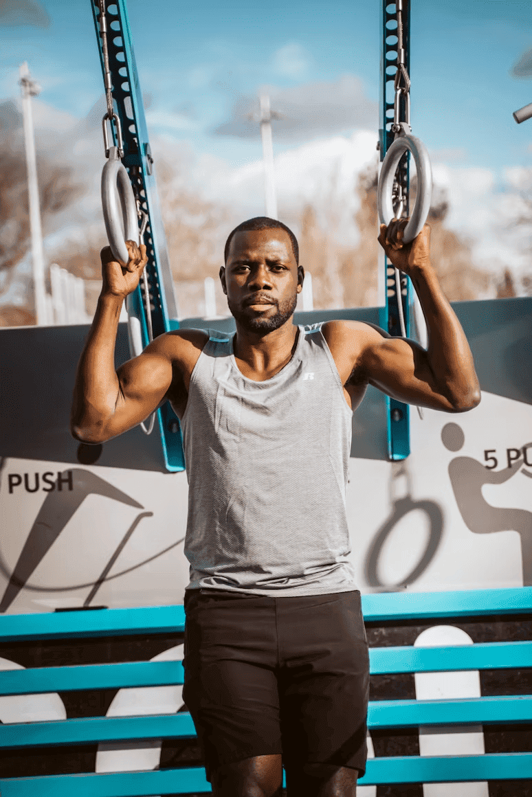 A member training on gymnastic rings at a Bardge partner fitness center